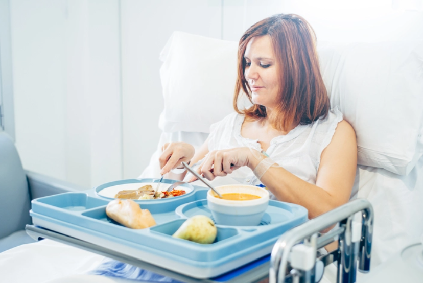 Woman in hospital bed eating
